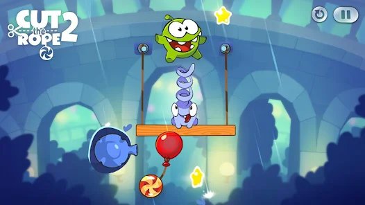 Om Nom navigiert durch ein lebhaftes Level voller Seile und Sterne in Cut The Rope 2